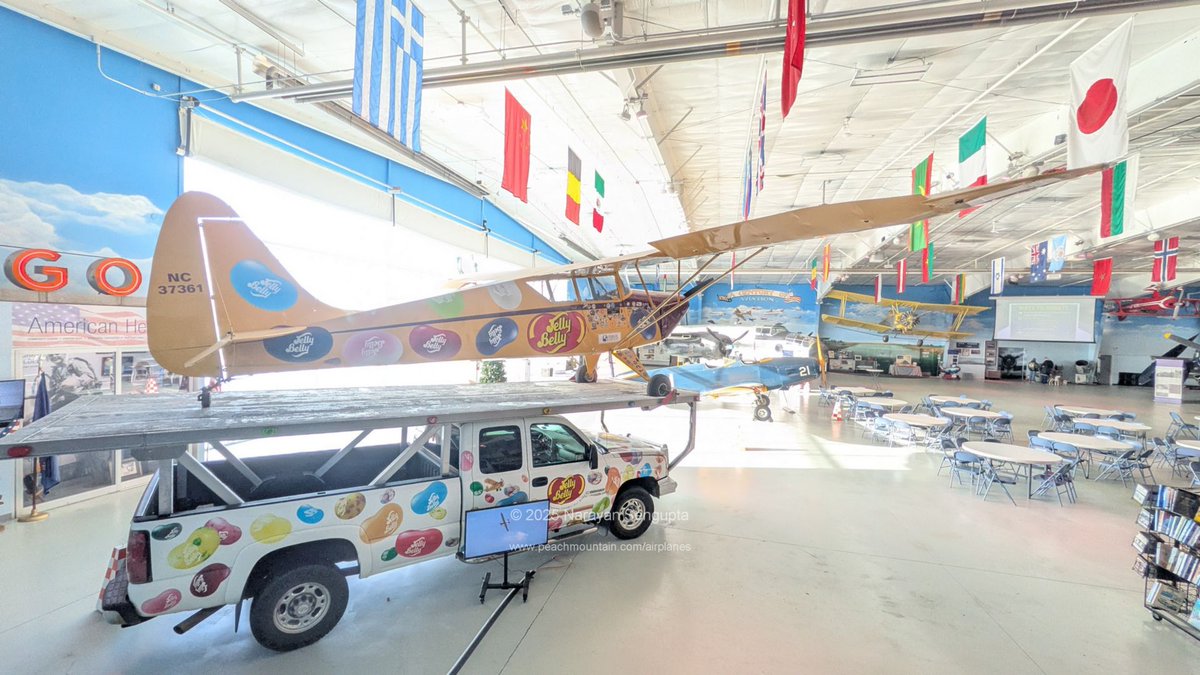 USAS_WW1's tweet photo. Jelly Roll + Canadians + Greenland trend. This beautiful festive Jelly Belly monoplane is at the Fargo Air Museum in North Dakota, south of Canada. The architects did a great job making the two hangars beautiful and expansive with a nice overlook in Hangar 1. https://t.co/NAQTZyrtmx