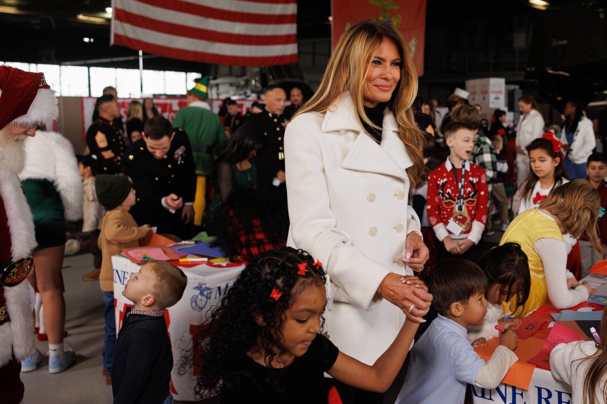 USMC's tweet image. First Lady Melania Trump, @FLOTUS, visits Marine Corps Base Quantico to take part in Toys for Tots alongside Marines and @USNavy Sailors.

Mrs. Trump told a story to children in attendance, helped sort toys for Toys for Tots, and assisted making Christmas cards. 

#MarineCorps…