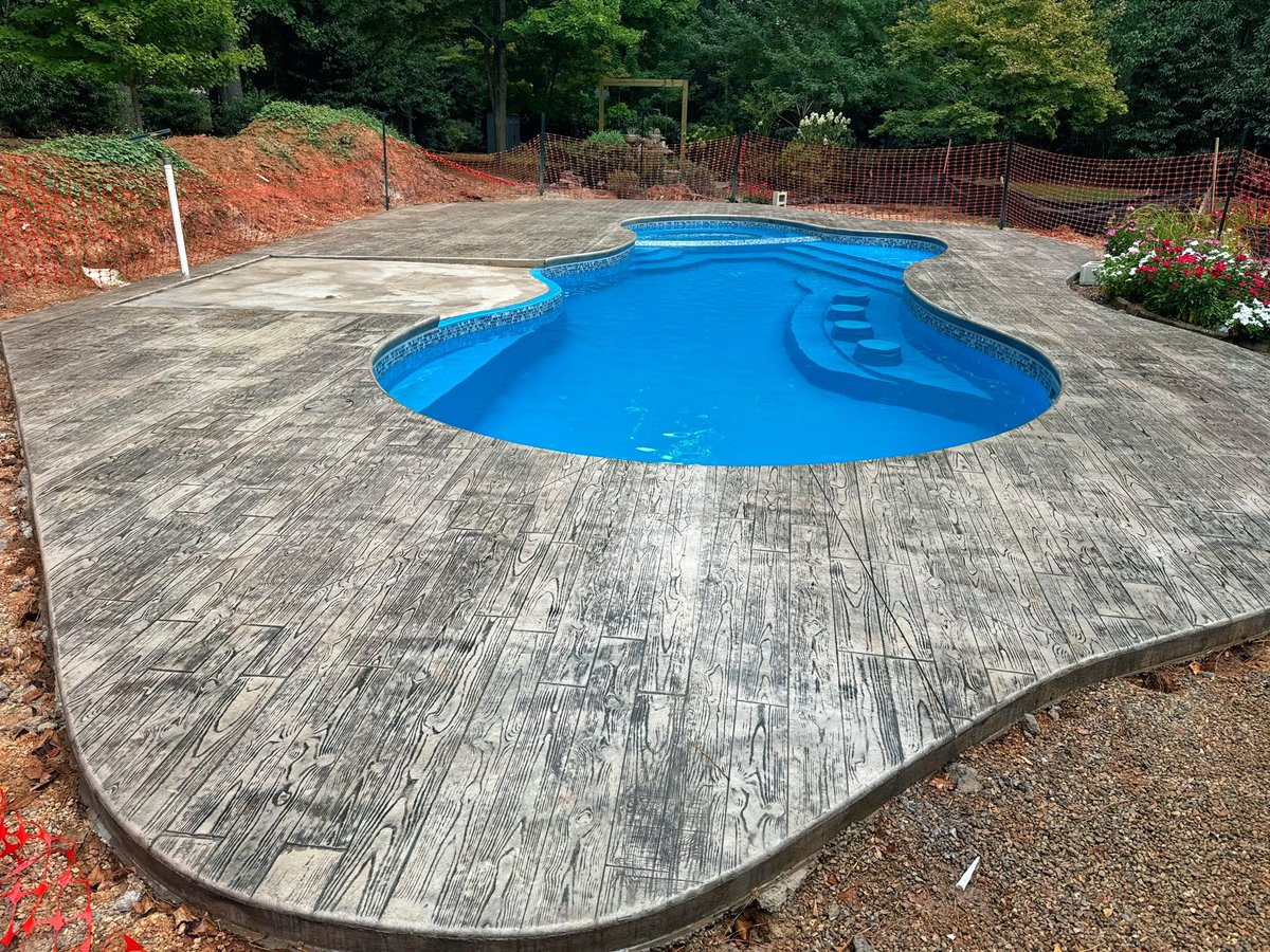 PoolscapesCLT's tweet image. The stamped and stained concrete pool deck for the Pleasure Island #fiberglasspool model. #pooldeck