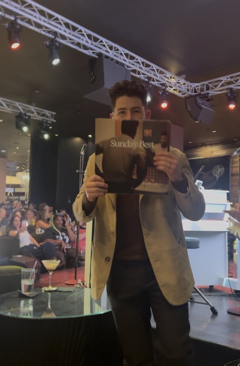 musicforandrew's tweet photo. Different angles of @nickjonas showing me album of the year https://t.co/c8oEx7H8kw