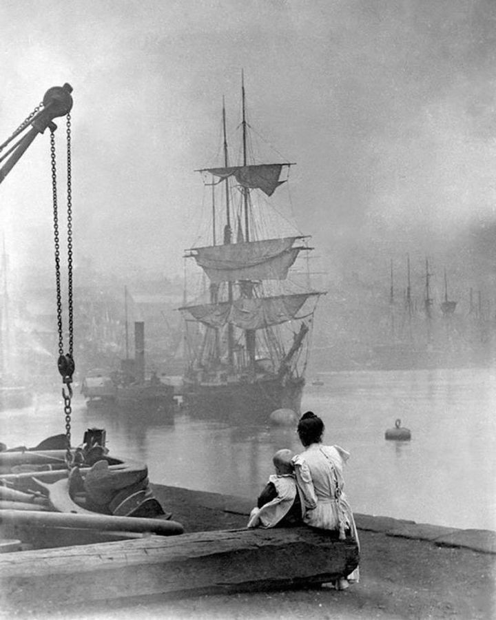 Mother and daughter watch a tall ship navigate the Thames in London, 1880.