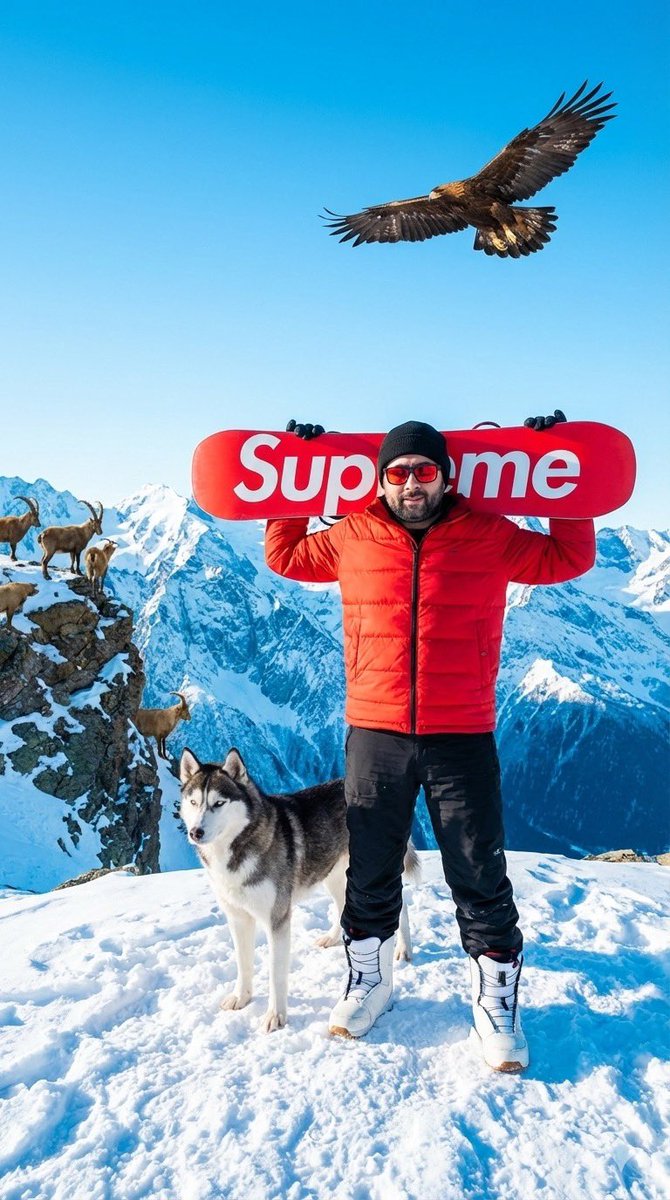 AliCanAri91's tweet photo. Gemini 🍌

Promp:

Create a photorealistic image of a man (use the uploaded photo for 100% accurate facial reference) standing on a snowy mountain peak. He carries a bright red snowboard with brand name "supreme" in it, across his shoulders and wears a red puffer jacket, black beanie, red sunglasses, black snow pants, and white snowboard boots.

Place him in a high-altitude mountain landscape with sharp snowy peaks under clear daylight. Add a husky standing beside him and mountain goats on a nearby cliff. In the distance. A large eagle flies overhead with wings spread.

Lighting is crisp and bright, with cold blue shadows on the snow and warm light on the face and jacket. The mood is bold, adventurous, and modern. The style is sharp, clean, and photorealistic with a winter sports vibe.