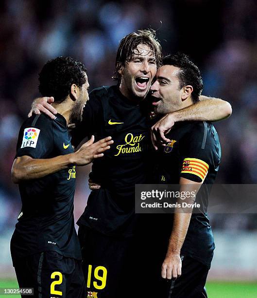 I see Dani Alves and Xavi Hernandez.

Guess the other player.