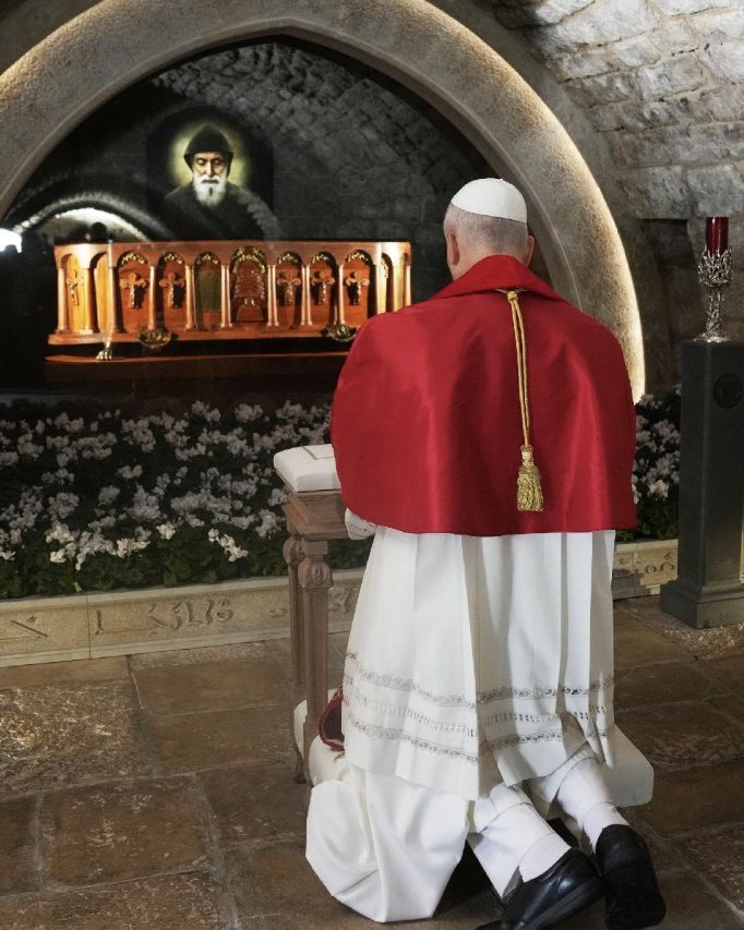 Pope Leo praying at the tomb of St. Charbel