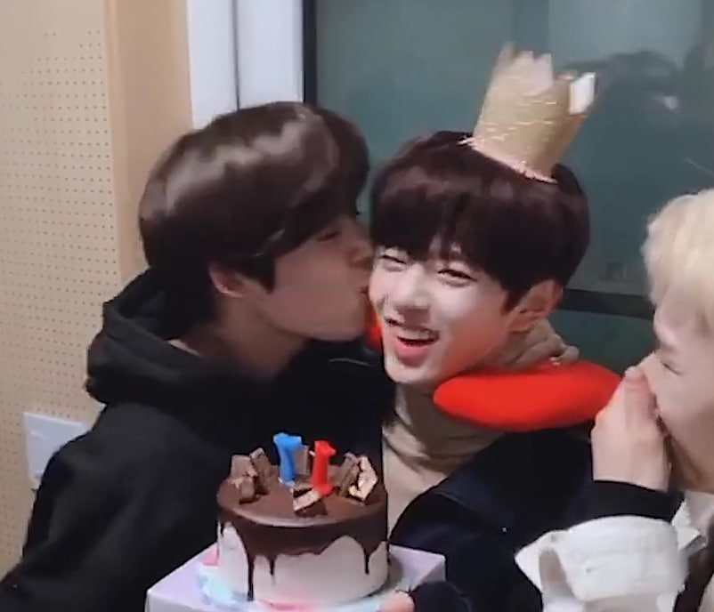 The first shot we see in the music video is the scene where the boys blow out a candle on a cake together, celebrating a “birthday.” Kangmin is wearing a crown on his head, and later the members try to kiss him on the cheeks.

I immediately associated this with Kangmin’s first BD