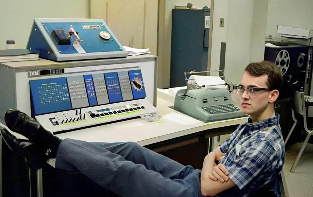 archeohistories's tweet photo. Man chilling at the console of an IBM 1620 computer, 1960s...

This image shows a young operator casually leaning back at the console of an IBM 1620, a computer introduced in 1959 and affectionately nicknamed the “CADET.” Unlike massive mainframes that filled entire rooms, the IBM 1620 was designed as an affordable scientific computer for universities, labs, and engineering departments. It was slow by modern standards, but groundbreaking at the time, allowing researchers and students to run calculations that once required slide rules or mechanical calculators.

The console seen here includes rows of indicator lights, toggle switches, and a typewriter-style input device. Programs were loaded using punched paper tape or punched cards, and the machine would process data step by step, often literally visible through the blinking lamps on the control panel. For many who used it, the 1620 was a first encounter with real computing power.

This relaxed scene reflects a lesser-known truth about early computing: long stretches of waiting. Operators frequently lounged, read books, or socialized while programs ran or data loaded. The combination of cutting-edge technology and downtime created a culture uniquely its own inside computer rooms of the 1960s.

The IBM 1620 didn’t use hardware circuits for arithmetic. Instead, it stored addition and multiplication tables in memory, earning it the joking nickname “Can’t Add, Doesn’t Even Try.”

© Reddit

#archaeohistories
