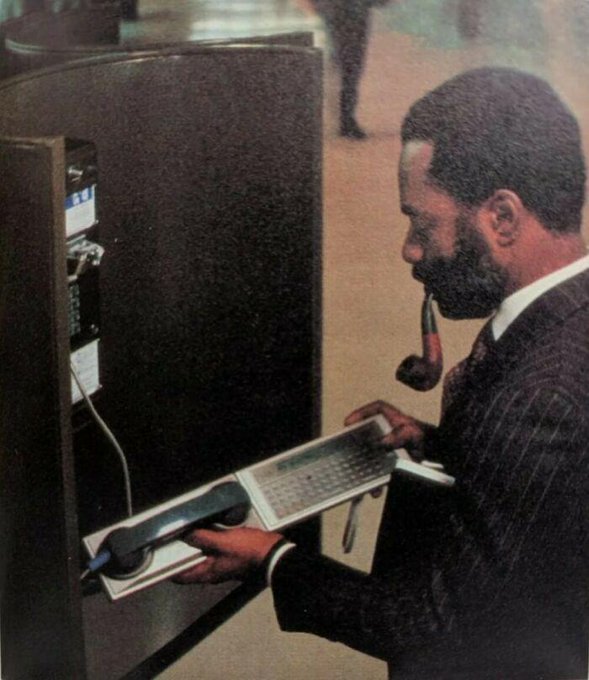 Rainmaker1973's tweet image. Man checks his e-mail over a public pay telephone using a panasonic Rl-P4001 acoustic coupler dial-up modem attached to a Panasonic Rl-H1400 Hhc hand-held computer in the early 1980s.