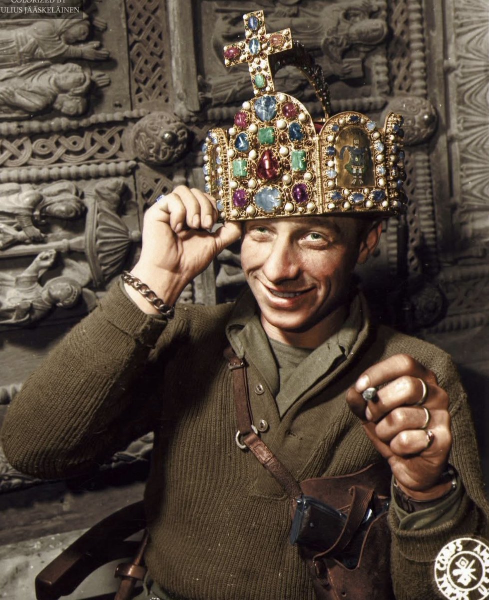 Ivan Babcock of the U.S. Army photographed wearing the crown of the Holy Roman Empire in a cave in Siegan, Germany, in April 1945. The cave had been used by German forces to store valuable items.

(Credit: History In Color)