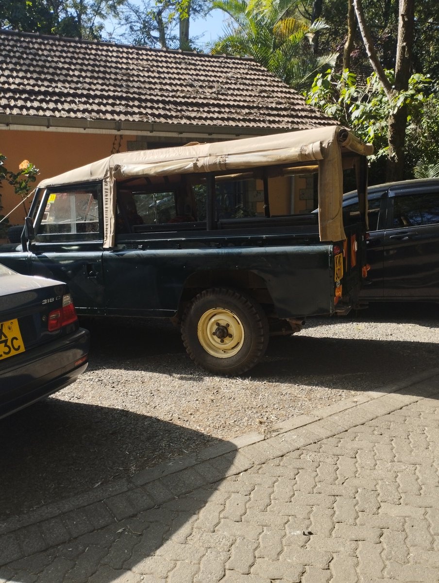 Vintage yellow steel wheels and a canvas soft top