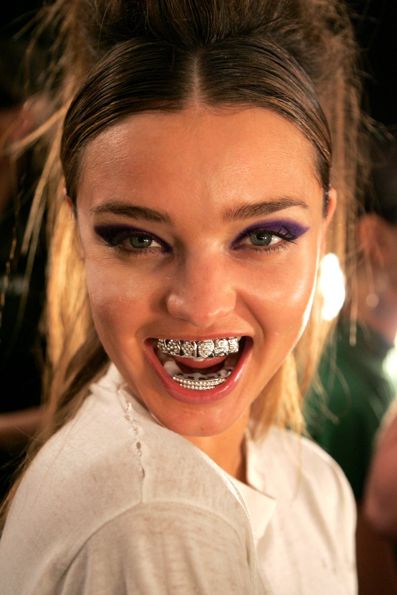 ComplexStyle's tweet image. A model wearing grills backstage at the Baby Phat by Kimora Lee Simmons Spring 2007 show