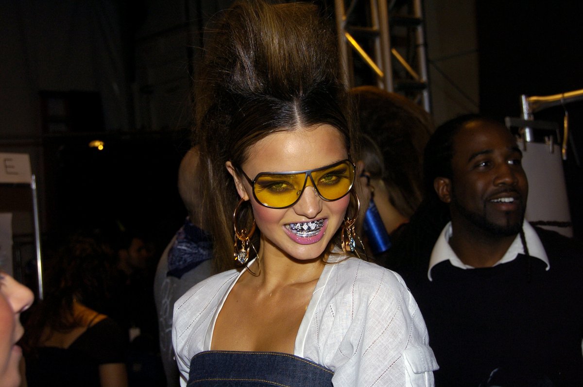ComplexStyle's tweet image. A model wearing grills backstage at the Baby Phat by Kimora Lee Simmons Spring 2007 show