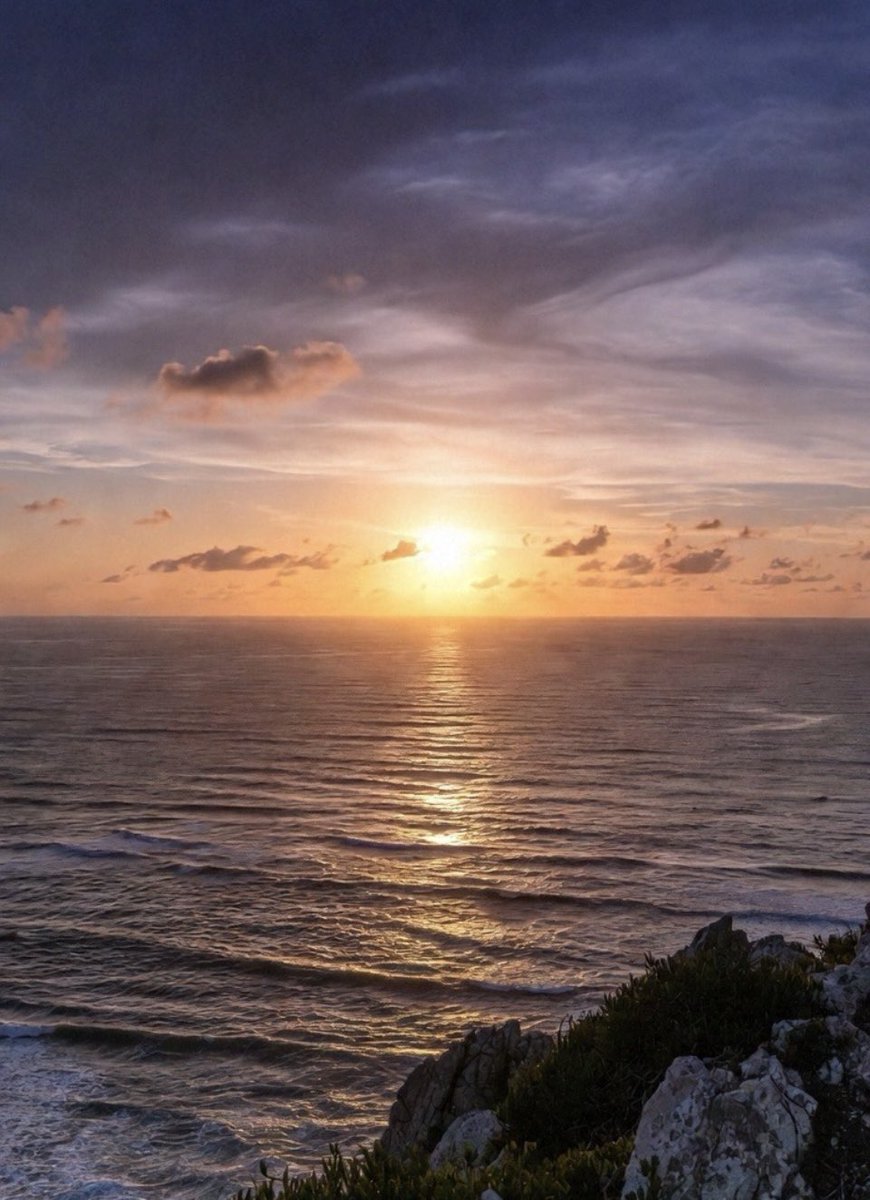 The golden sun melts into the endless sea, a silent promise painted with light.
The waves whisper, the rocks wait,
the sky and the horizon merge into one.