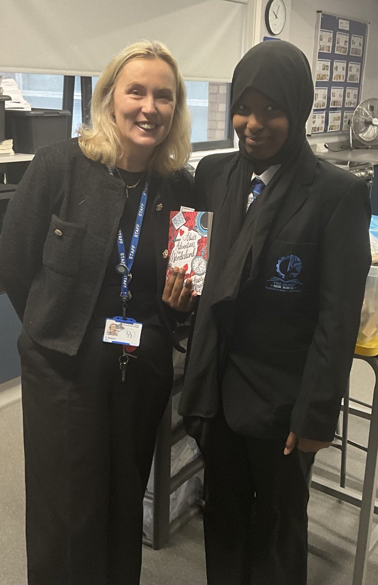 Day 3 of Book Gifting Advent -  congratulations to Firaatoli in Y7 who received Alice's Adventures in Wonderland! Pictured with Form Tutor, Mrs Brigham. 
And our Elves have been up to mischief with the book jackets - can anyone help Elphaba???? 😮😮😮 #thederbyhighschool