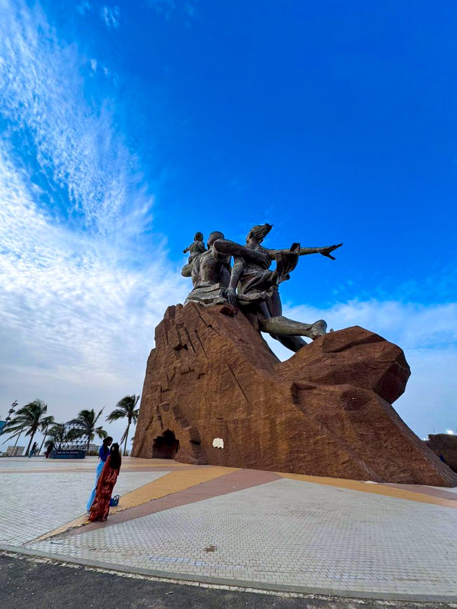 emmiwuks's tweet photo. DAY157 NIG2USA ON A BICYCLE 🇳🇬🚴🏽‍♂️🇺🇸
Today, I stood before the African Renaissance Monument in Dakar, and for the first time in a long while, my heart went quiet.

This statue is not just stone and bronze. It is a giant reminder of who we are. A man rising with power. A woman standing with strength.
And a child, pointing to the unknown.
That child unsettled me.
Because he wasn’t just pointing at the sky.
He was pointing at destiny. He was pointing at the same direction my bicycle has been dragging me for months now, from Africa to the USA.

And in that moment, fear crept in. Not the fear that makes you run. The fear that reminds you that your dream is bigger than your strength. That your journey is louder than your voice. That once you start, Africa itself begins to watch you.

This road has broken me, rebuilt me, tested me, healed me. Lonely nights. Cold winds. Silent prayers. And yet, here I am. Still riding.
Still believing.
Today, this monument spoke to me, “You may leave this land physically, but you will never leave it spiritually.” No matter how far I go,Africa is riding with me.

Together we Ride. Together we rise.
VIVA AFRICA 🌍.

The Journey continues to Mauritania.. Soon. 

#NIG2USA #Senegal  #adventure