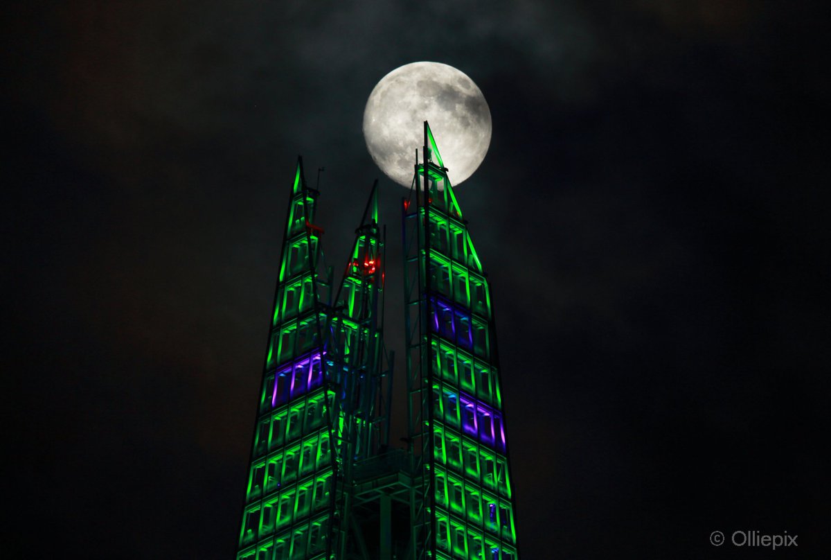A 98% full moon known as the Cold Moon, which marks the start of winter as it occurs near the solstice. The Cold Moon is 2025’s third #supermoon in a row. Here it competes Wednesday, Dec. 3, 2025 with the Shard’s Christmas light show, in London. #CoolMoon  #OlliepixFlickr