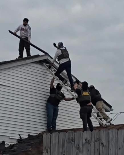 Timodc's tweet image. Masked fucks pointing weapons at roofers outside New Orleans. No probable cause just targeting Hispanics working construction.