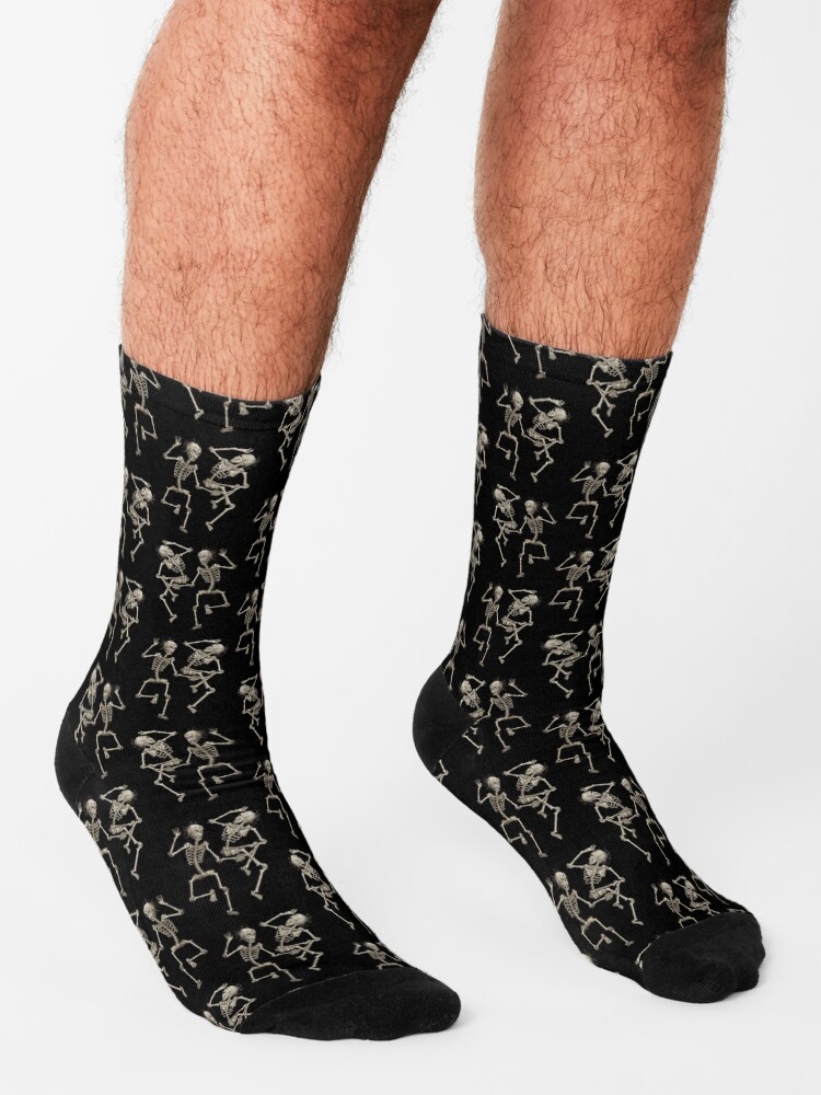 PDyaczenko's tweet photo. Did you know the Dance Macabre was once depicted with skeletons wearing jester hats for a humorous twist? Step up your style with our Dancing Skeletons Pattern Print Socks! Check them out here: https://t.co/gwVVhs3mk1. #DancingSkeletons #PatternPrint #Socks #DanceMacabre #SpookyFashion #Redbubble #SkeletonStyle #UniqueSocks #HalloweenWear #FashionAccessory
