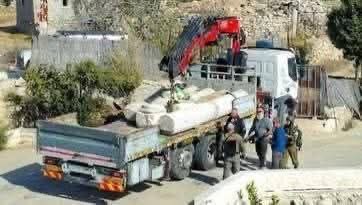 Israeli troops steal ancient stone columns from the archaeological site of Al-Burj during an invasion of Al-Mazra’a al-Sharqiya, near Ramallah