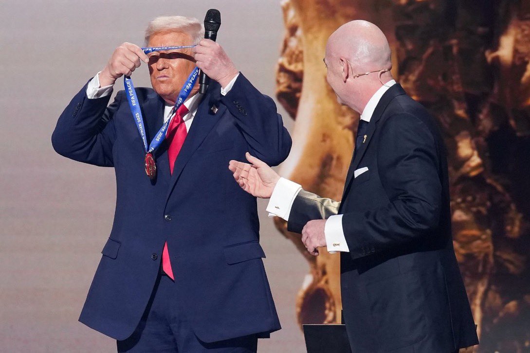 LHubich's tweet photo. Trump was in such a hurry to put on his new Fake Peace Award medal today he couldn’t hand off the microphone.  Like a child with a bag of Halloween candy.  🤣😂.  I bet he sleeps in it tonight. Imagine him taking a piss and a selfie with it on at 2 a.m. tonight. 🥇 https://t.co/snwDP9pAPn