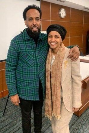 DHSgov's tweet photo. Criminal illegal alien, Abdul Dahir Ibrahim has been linked to Minnesota's top sanctuary politicians. In these pictures Ibrahim can be seen with @GovTimWalz, @Ilhan, and @OmarFatehMN.

Ibrahim was convicted in Canada for Asylum and Welfare Fraud prior to his entry into the United States. On April 3, 2004, an immigration judge ordered Ibrahim removed, citing the significant amount of fraud associated with him.

Bye-bye, Abdul.
