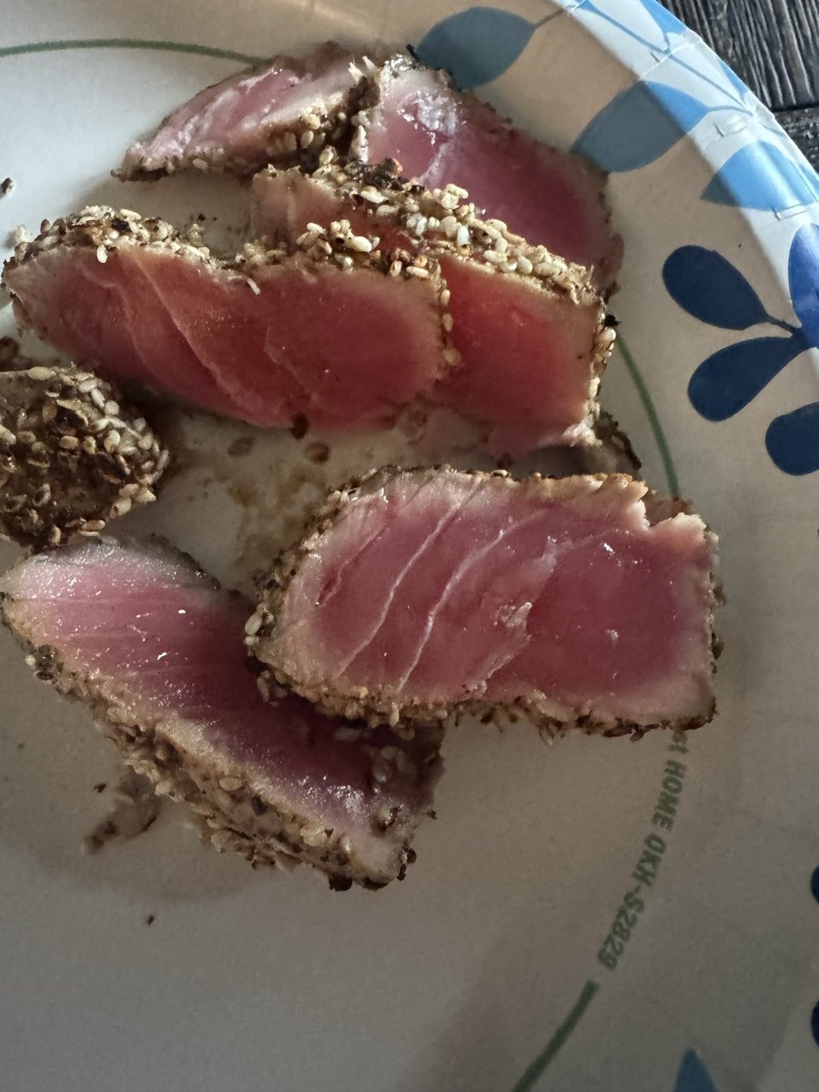CarmichaelDave's tweet photo. This little hack I picked up- 

At Winco (and I’m sure other places), they have these tiny little frozen tunas. Maybe 2-3 bucks max. Flash frozen. 

Defrost in warm water 

Throw in a tiny ziploc with soy sauce and black pepper 

Throw a bunch of sesame seeds, a pinch of salt, and a big pinch of pepper into a bowl. 

Take the tuna out and roll in the seed mixture till fully coated. 

Turn a pan on high, drop in the tuna when it’s hot. 

Count to 60 and flip. Repeat. 

30 seconds for each side (I use chopsticks to stand it up)

Slice and dip in soy sauce. If you have a jalapeño, slice it and eat it with. 

Super cool and cheap snack.