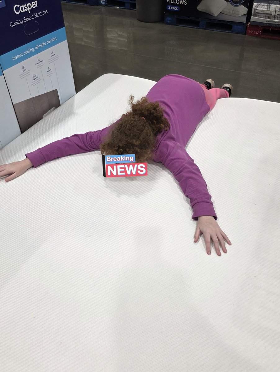 E1 tries out the mattress at costco