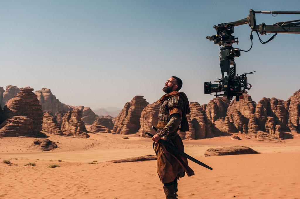 sharlto's tweet photo. Back in Saudi! 
4  years ago I spent 5 months in this desert with a crazy-talented crew from 38 countries: camels, sunsets, dune BBQs, and one of the last war epics shot fully on location. 
(Someone pranked Sir Ben Kingsley?) DESERT WARRIOR premieres tonight at  #RedSeaIFF https://t.co/v8oKE2vD3S
