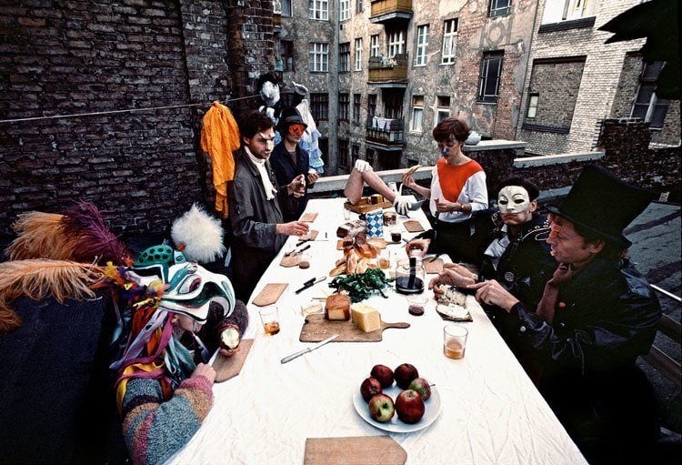A pantomime theater group eats on a rooftop in East Berlin, 1984.