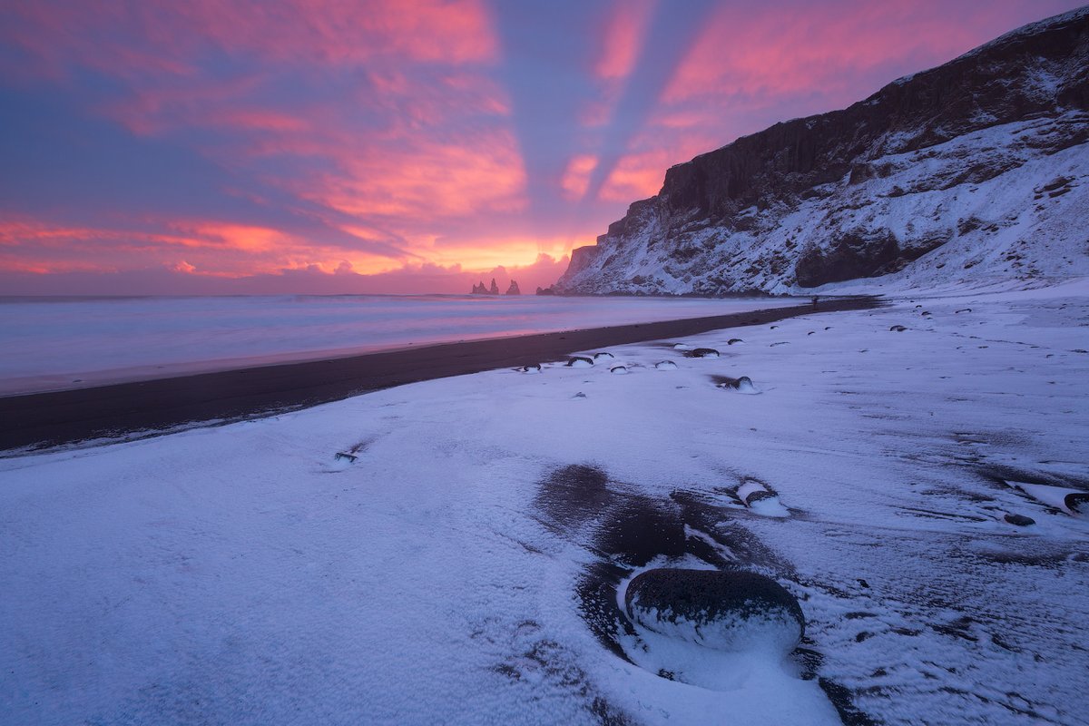 Vík in winter is where Iceland’s wild side goes full fairytale, with black sand, snowy cliffs, and moody skies. ❄️🖤

Fun fact: Reynisfjara, the famous black sand beach next to Vík, is lined with towering basalt columns and the Reynisdrangar sea stacks offshore. 🌊🪨

#iceland