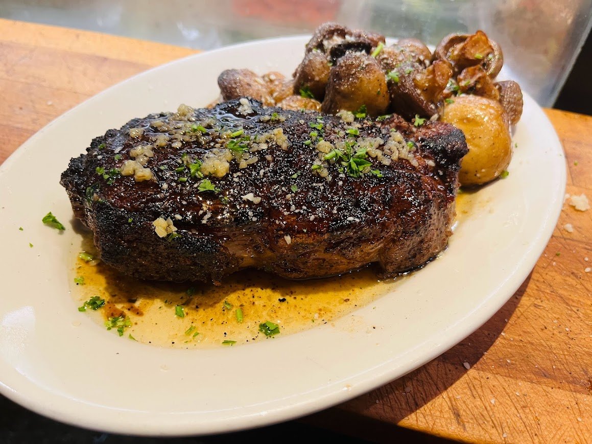 4thBase1's tweet image. Experience the sizzle of our 16oz Boneless Ribeye at 4th Base Restaurant! Juicily char-grilled to your liking &amp;amp; topped with your choice of mushrooms, onions, or peppers. Plus, a side of potato or starch! 🥩🔥#RibeyeLovers #GrillMasters #4thBaseRestaurant
