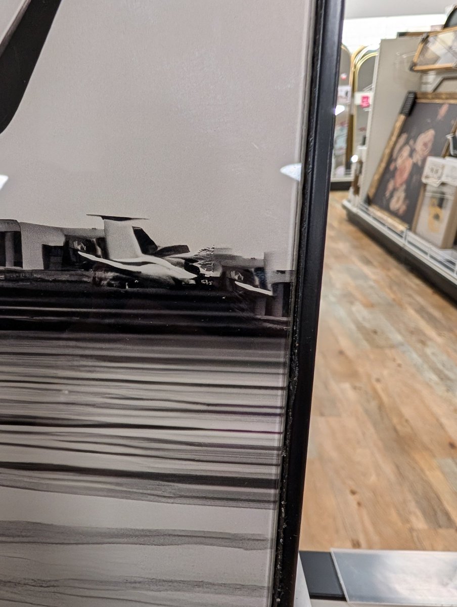 unixpickle's tweet image. Spotted at Home Goods: an AI-generated image for sale to hang on your wall.