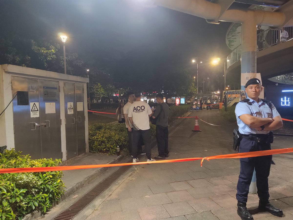 RazvenHK's tweet photo. Happening now: A young man seen handing out fliers with the "4 demands" asking for government accountability and continued support for residents after the Tai Po fire is being questioned by police officers. https://t.co/upumDiorv8