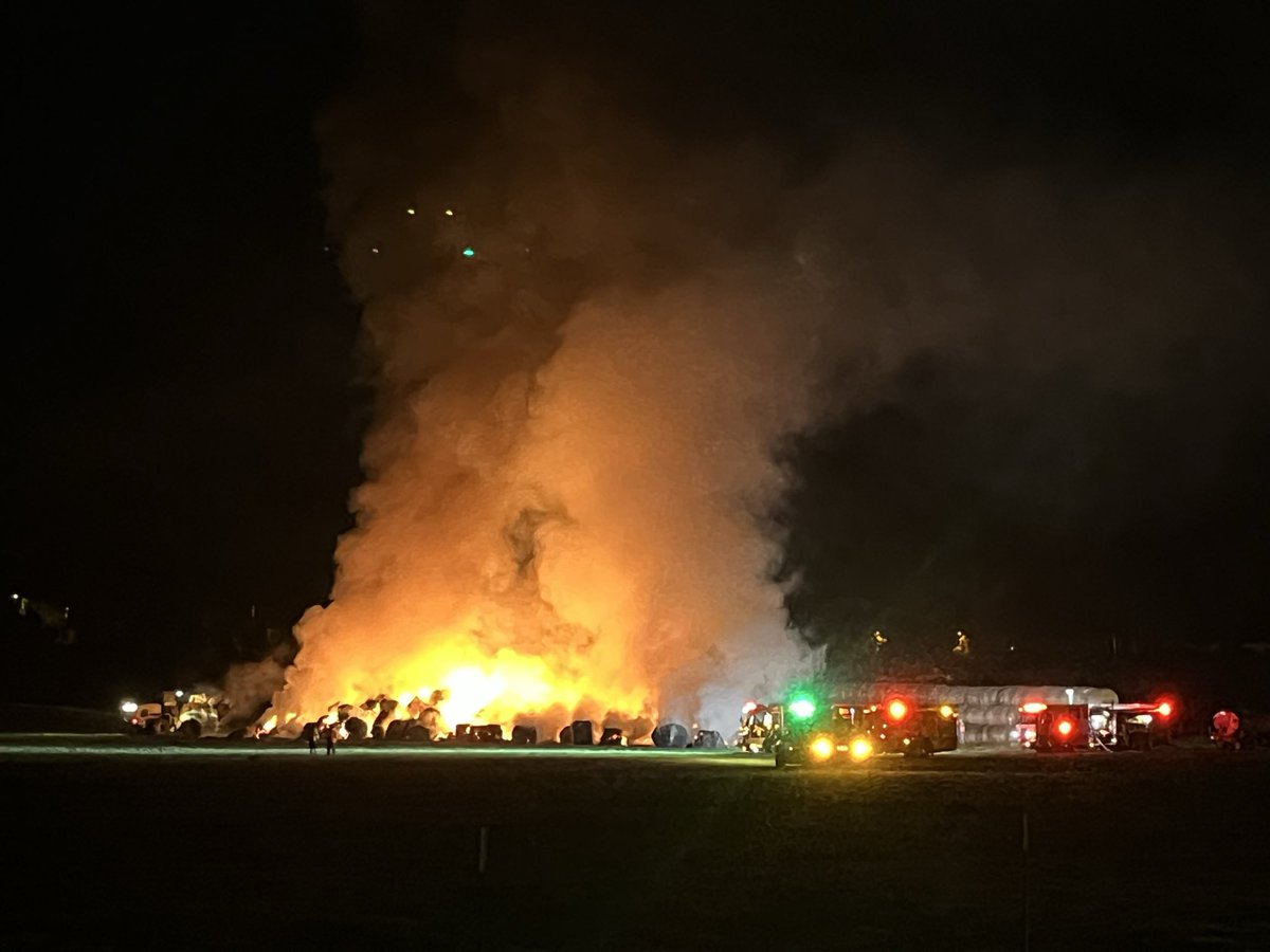 SDFD's tweet image. Multiple SDFD crews have been working to extinguish hundreds of large rolled and stacked hay bales on fire near 15750 Old Milky Way since 11:20 p.m. last night. @calfiresandiego is on scene supporting with dozers. Please note smoke may be visible in the area this morning.