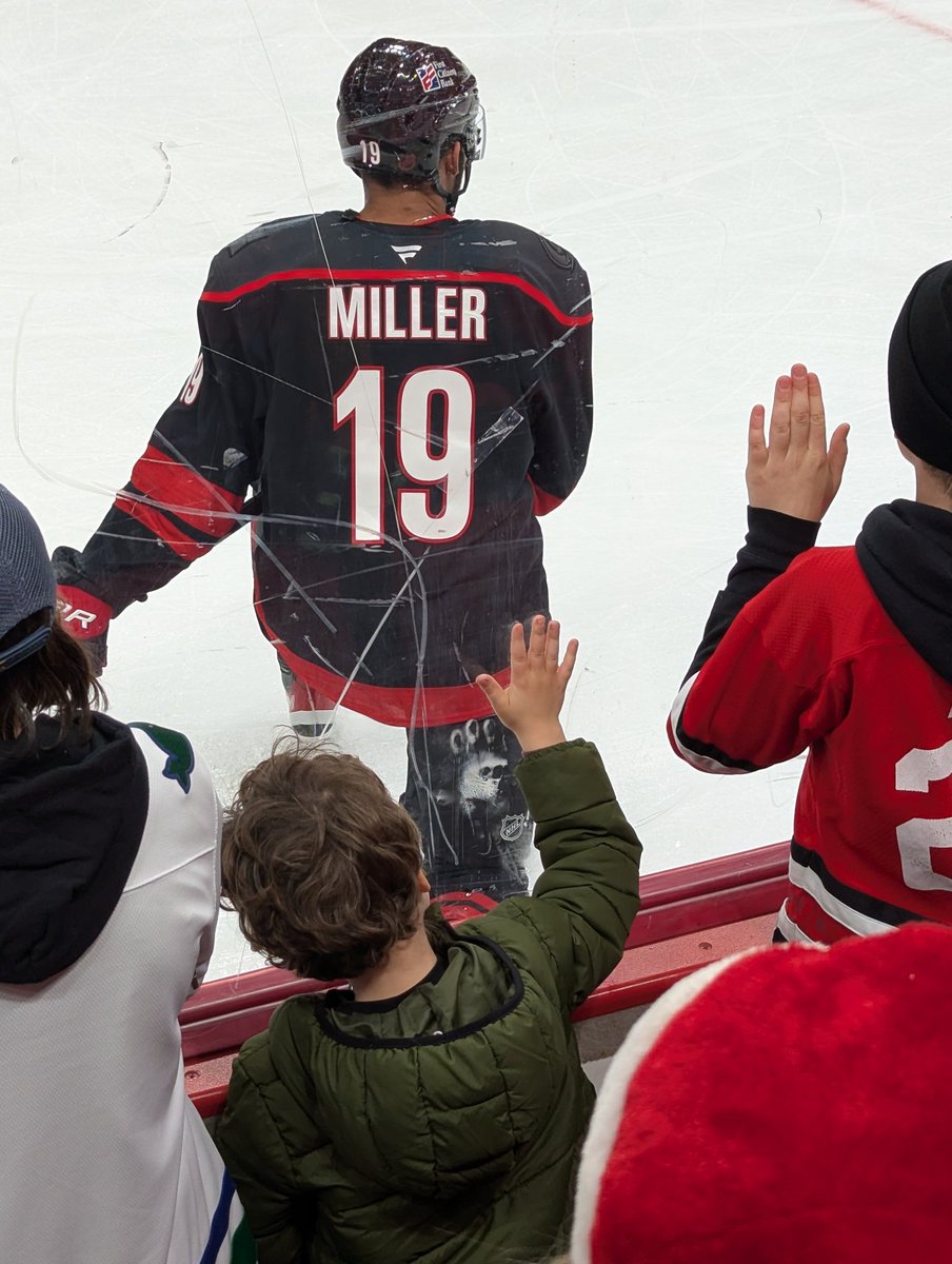 DrSchmidt's tweet photo. Our first time at the glass for warm-up. Son's become a super fan of the game and @Canes, a player himself now. Getting puck was incredible, but the interaction from @kandre_miller, waiting for a fist bump - that memory is forever.  He's built forever fans in us #CarolinaCulture https://t.co/VMQqjjS2uW