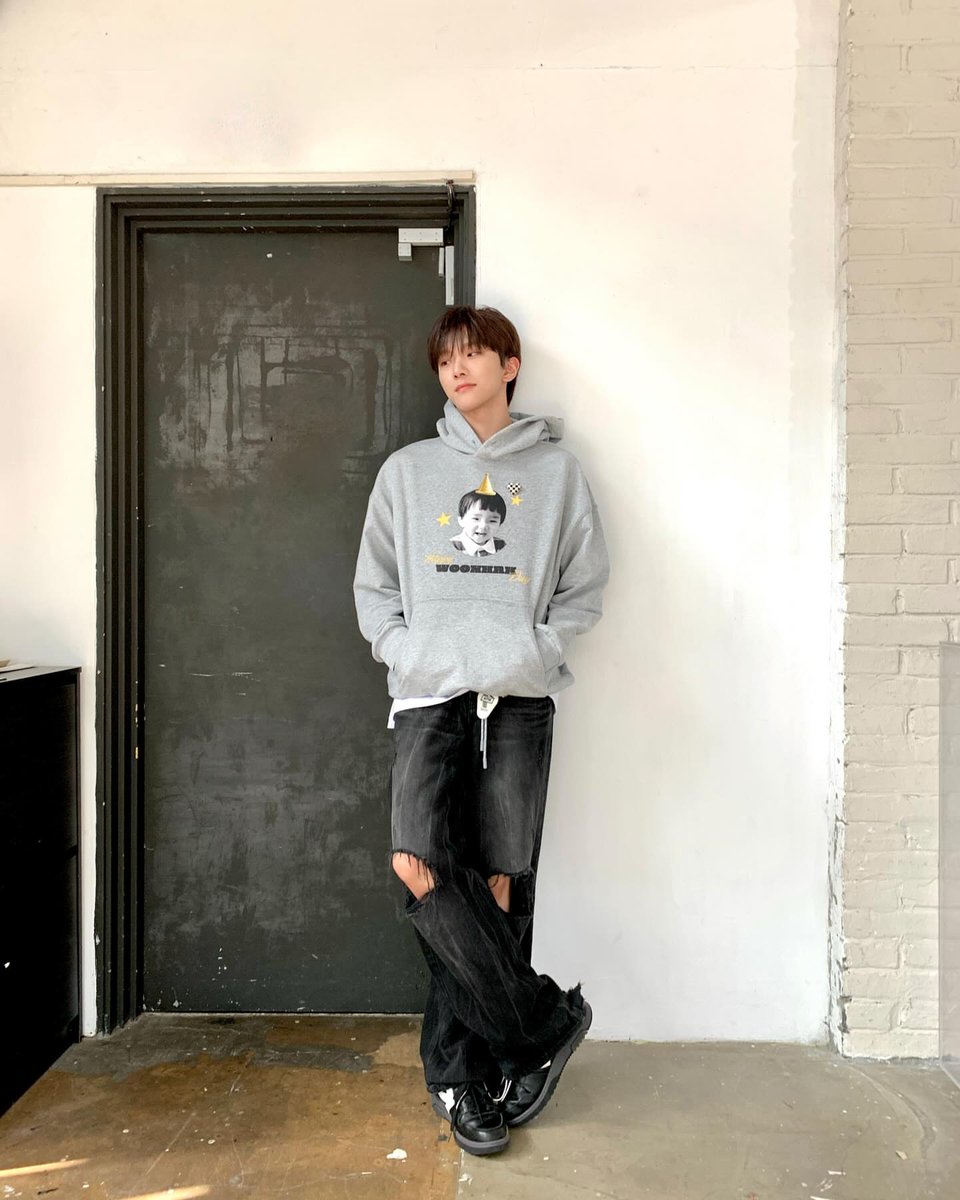 Hood up, a soft grin curling at the edges, he shows a funny face as if gifting the day with his own small spark. The childhood photo on his chest mirrors that same playful light. On his special day, even the simplest expression turns the room a little warmer and brighter.