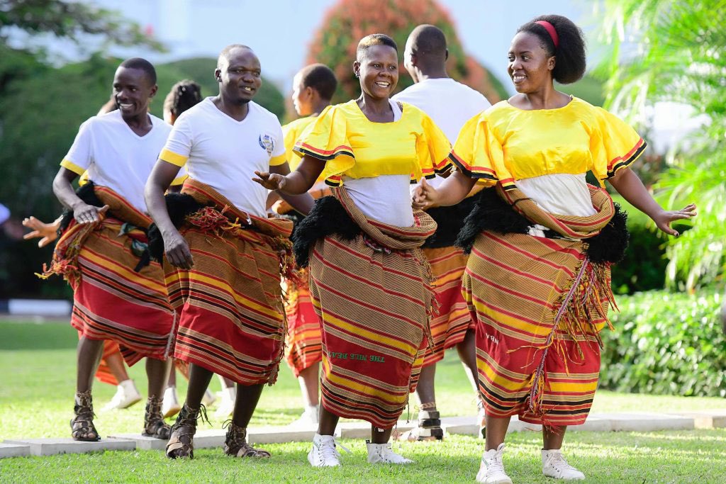 56Tribe's tweet photo. Did you know Busoga’s Tamenhaibuga dance? 

Tamenhaibuga literally means “do not break the drinking gourd.” In traditional Busoga, elders enjoyed mwenge bigere (local beer) using a gourd (ibuga) as their drinking vessel. When someone got too excited and began dancing recklessly, they often dropped and broke the gourd. Their friends, who were singing, drumming and cheering, would warn them with the phrase “Tamenhaibuga!” a name that eventually became the identity of this vibrant Basoga dance.

How it is danced:
Tamenhaibuga is performed by both men and women, with smooth, circular waist movements at the centre of the dance. The upper body moves proudly, while the arms highlight the dancer’s waist or head, emphasising grace and control.

Costume:
Women wear a sleeveless bra-like top with an open midriff and a kikoyi wrapped just below the knee to allow free movement. A prominent, trough-like waistband accentuates the rounded waist motions.
Men dress similarly, either bare-chested or in a vest.

Instruments:
The xylophone (embaire) leads the music, supported by a rich ensemble of drums, the endumi (big drum), rhythm drums, and omugalabe (long drum) along with the endigidi (tube fiddle), ensaasi (shakers), and omulele (flute).

#tribe56