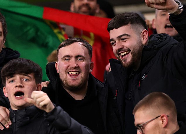Luke Littler celebrates.