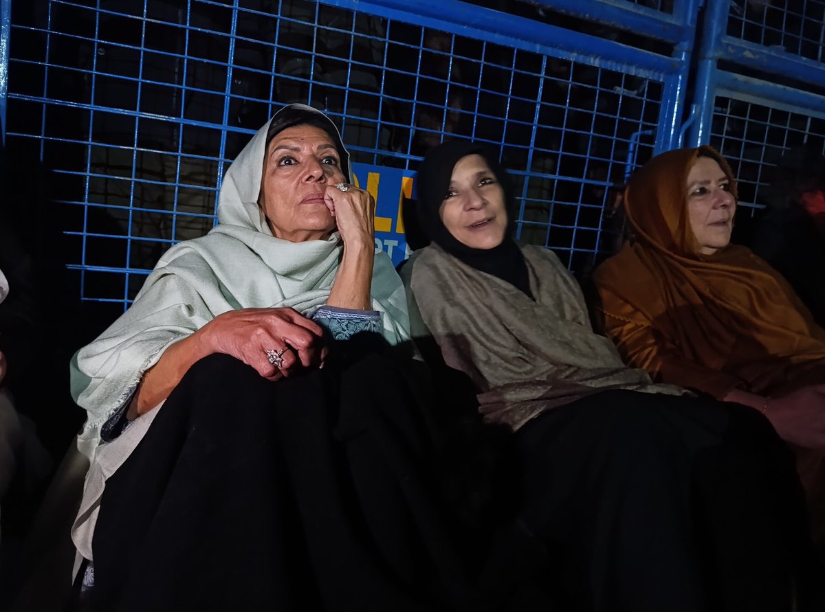 Imran Khan’s sisters are sitting on the road late at night, still waiting to meet their brother.