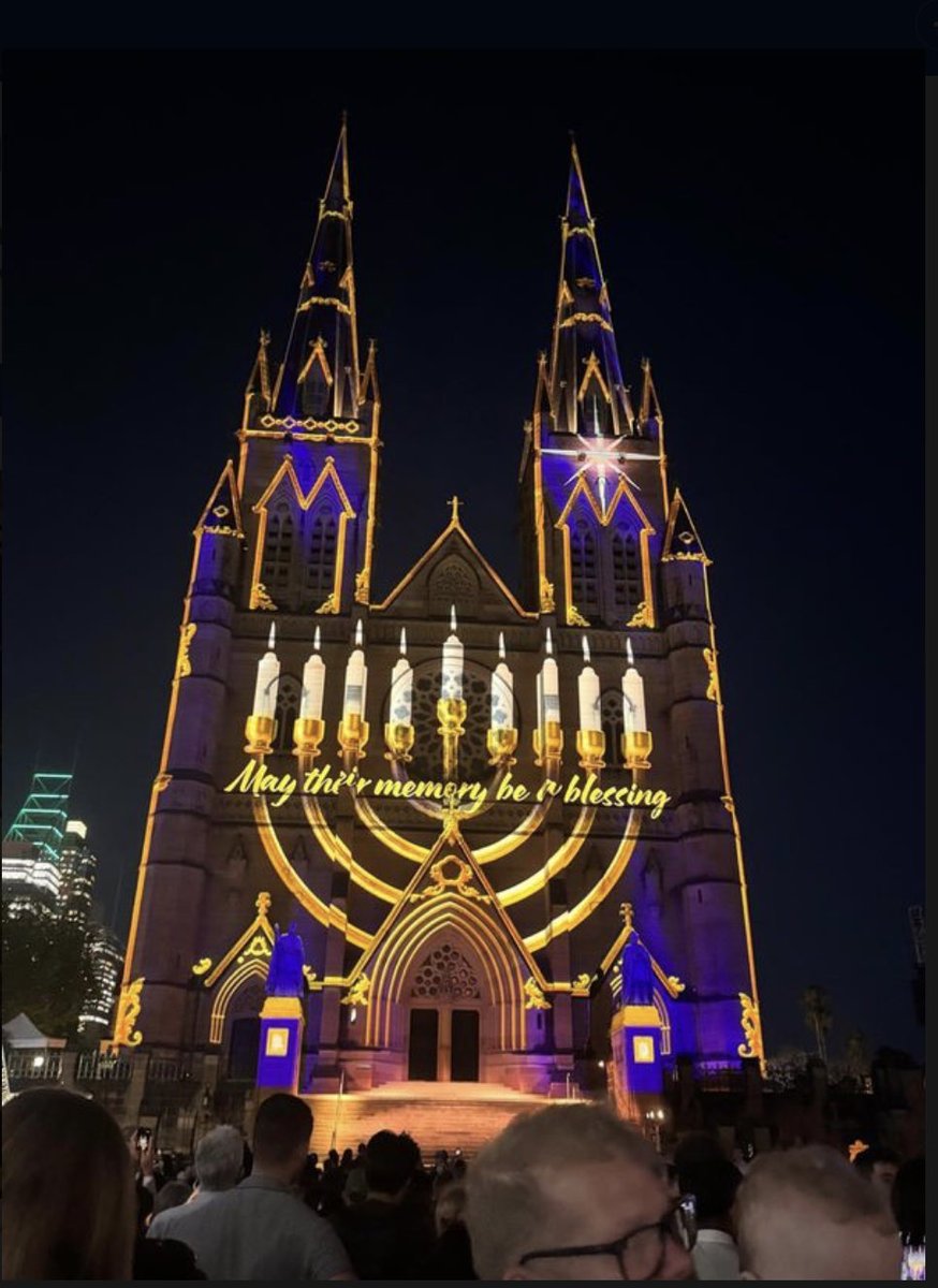 COLRICHARDKEMP's tweet image. Standing together against evil. At Christmas, a menorah was beamed into S. Mary’s Cathedral in Sydney.