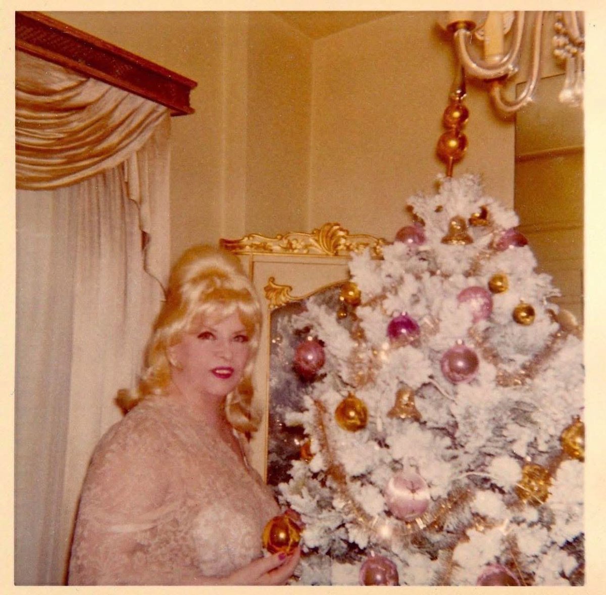 Mae West at Christmas in her apartment on the 6th floor of Ravenswood on Rossmore Ave. Mae moved into the apartment building in 1937 and remained there until her death in 1980.