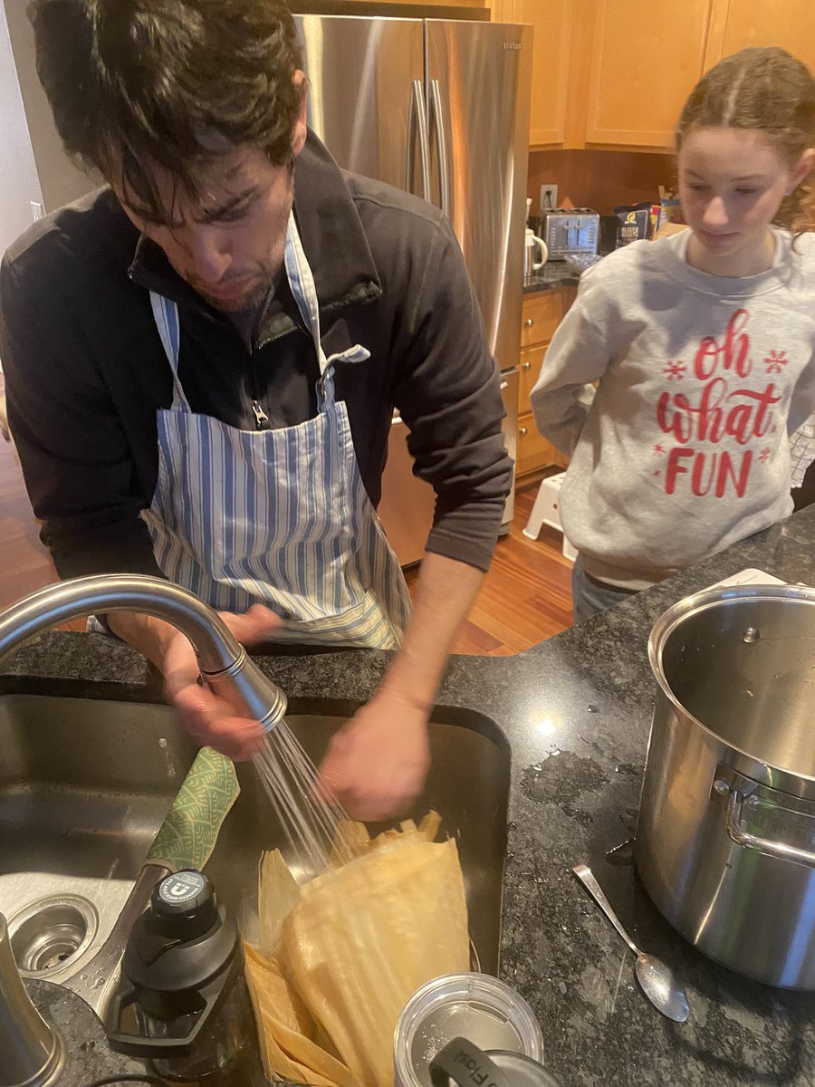 My brother, Stefan, teaching our niece, Rose, how to make tamales as my dad (and his) supervises.