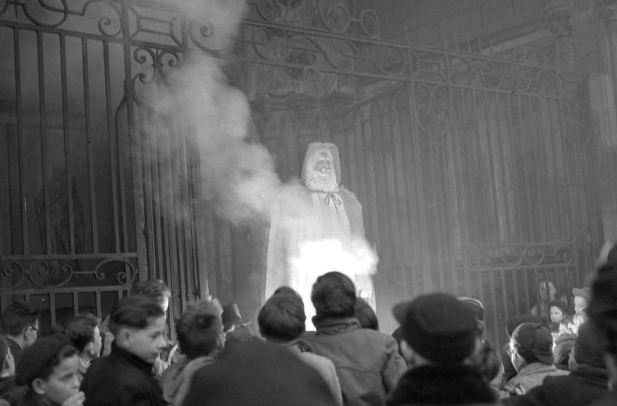 sonnysehra's tweet image. french catholics hanging and burning an effigy of santa claus in front of over 200 children to protest the “paganization” and commercialization of christmas (1951)