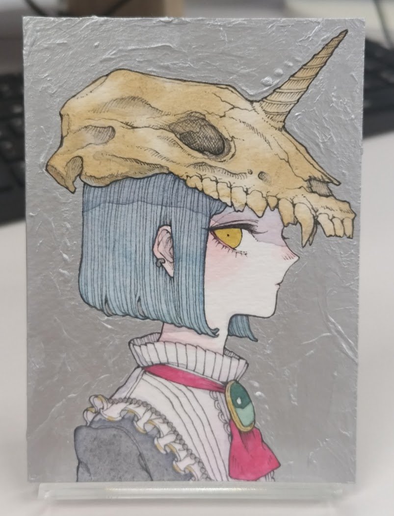 庭一さんの小品にご縁を頂きました。
……プロフィールを調べるまで、「ていいち」だと思っていました。
薄く塗られた一角獣の骨という文字通り幻想なモチーフと、背景にこれでもかと盛られた銀色が対照的です。
想像以上に分厚く、新たにより深い溝のあるケースを購入して保存しています。
<a href="/ut_281/">庭一🌱</a>