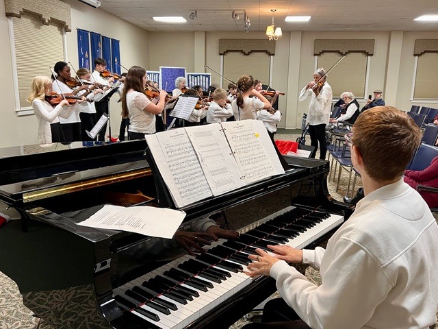 Suzuki Strings performed here on December 16th! About 25 young violinists ages 6-17 played for us, showing off the skills they've been developing under director Sue Ann Erb's guidance. She's been teaching the Suzuki method since 1972. Thanks to these talented students!