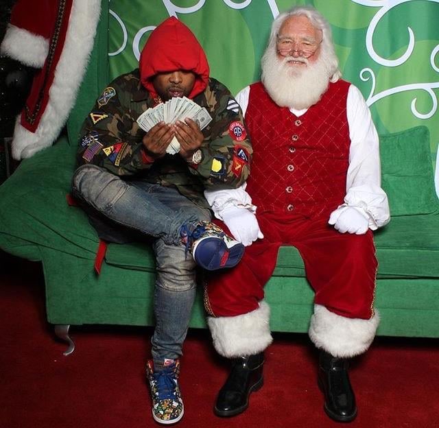 Steez_47's tweet image. Westside Gunn taking a picture with Santa Claus