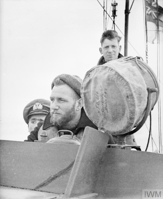 A bearded coxswain at the helm of a MTB looks across the waters of the Sicilian Channel.