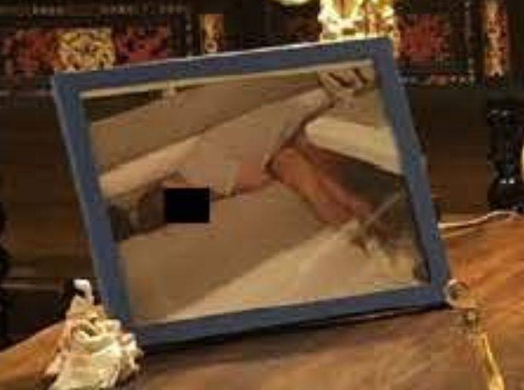 xIsraelExposedx's tweet image. In one of the newly released images from Jeffrey Epstein's island, during a meeting between Epstein and Steve Bannon, you can see an image frame depicting a passed out or drugged underage woman laying on a couch