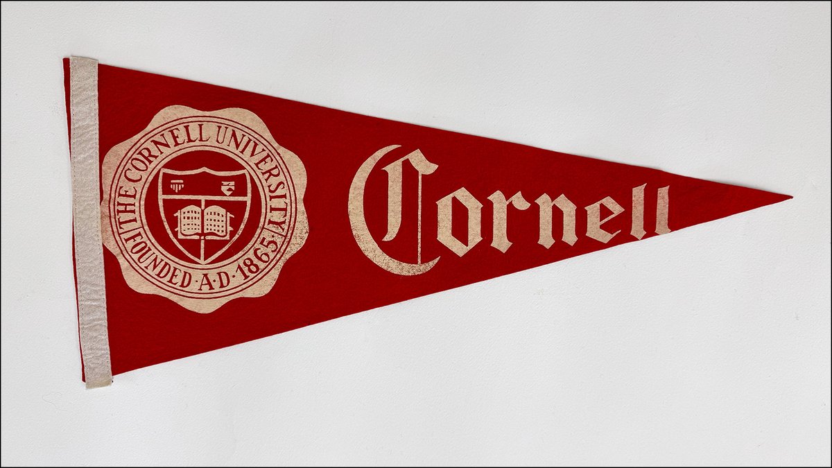 Cornell's tweet photo. Big Red memorabilia stretching back more than a century can be found in all forms and sizes: stick pins and brooches, bear-shaped emblems, game tickets, programs, banners, and much more.

But at Cornell and elsewhere, one of the most popular and longstanding items of school pride is the classic, triangular felt pennant—which, in Cornell’s case, is of course nearly always red—sporting bold lettering and a logo or insignia.

In preparation for a recent display by Rare and Manuscript Collections in the Kroch Library rotunda (@Cornell_Library), exhibitions coordinator Kate Carlin took a deep dive into Big Red pennants (and banners, too).

“They were interpreted in so many different ways,” she says, “for different groups or uses—general school spirit, athletics, colleges and majors, clubs, class years.”

As the Kroch exhibit explains, small triangular flags can be traced to the Middle Ages, when knights carried them. Later flown from ship masts, they were a means of communication with other boats.

Read about how, for generations of Cornellians, the humble pennant has been a tried and true way to display Big Red pride at https://t.co/AxKcusMK7a.