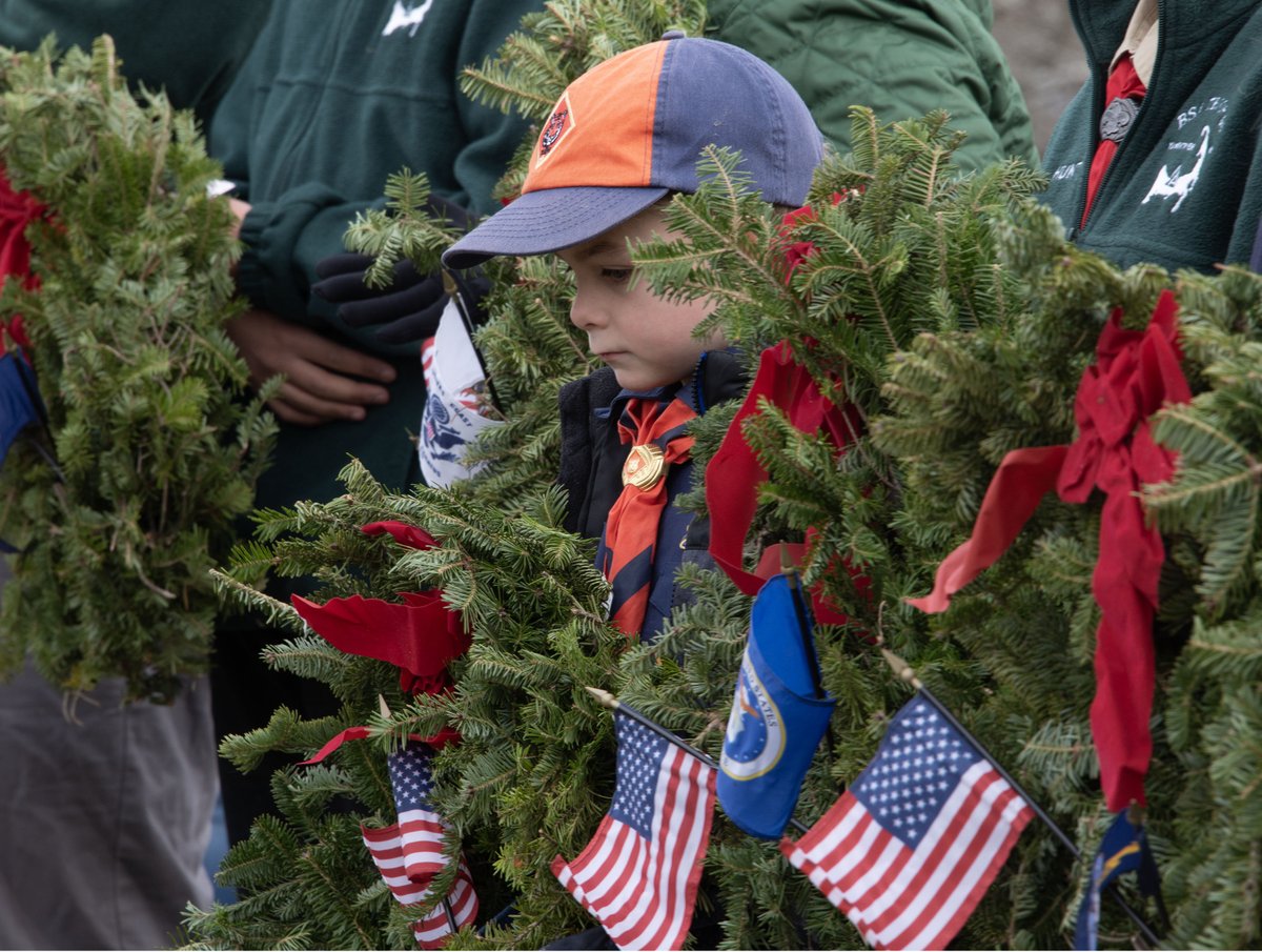 Yarmouth Cub Scout Bryce Boudreau bows his head for a moment of silence surrounded by wreaths for the branches of service that Scouts placed graveside during a Wreaths Across America ceremony at the Chandler Gray Cemetery in West Yarmouth. <a href="/capecodtimes/">Cape Cod Times</a>