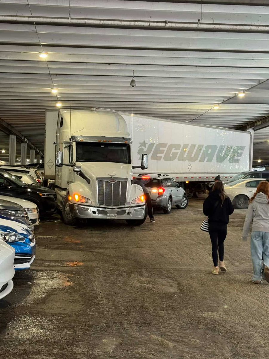 yegwave's tweet photo. This semi-truck driver thought it’d be a good idea to drive into a tightly packed parking lot at WEM. https://t.co/3dQEZkFOpc